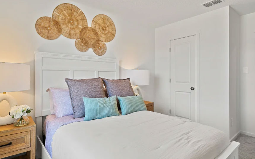 Closer view of a furnished secondary bedroom with a decorative wood headboard
